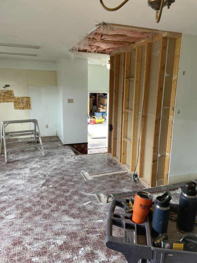 Another view of kitchen space in another stage of deconstruction showing removal of closets to create a more open space.