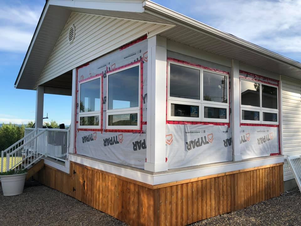 Photo of outside of spa room addition with before siding installed.