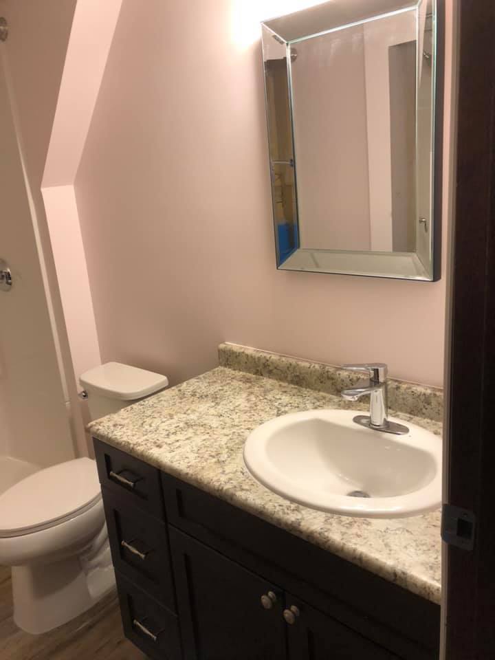 In this photo you can see the beautiful newly installed cabinet and counter for the sink.