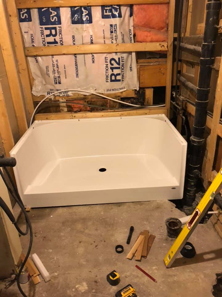 Photo showing installation of shower base