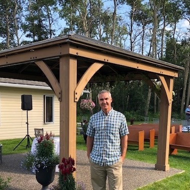 Photo of Steve in front of outdoor gazebo with exposed aggregate concrete base